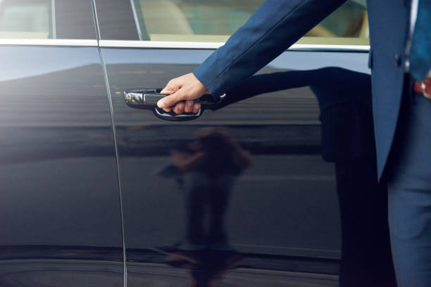 Cropped shot of a well-dressed man opening a car door